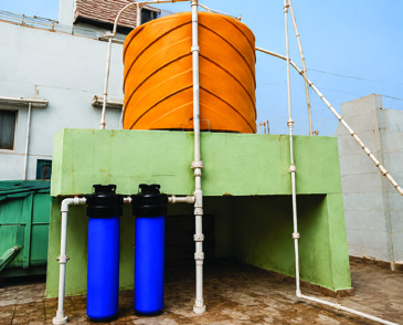 Rooftop overhead water tank with supply piping and filters